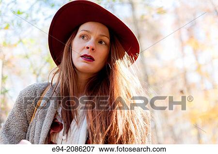 A 25 year old red headed woman in a forest setting in the autumn. View Large Photo Image Stock Photo - A 25 year old red headed woman in a forest setting in the autumn.. Fotosearch