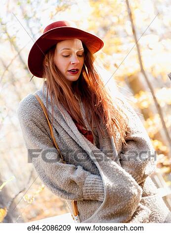 A 25 year old red headed woman in a forest setting in the autumn. View Large Photo Image Stock Photo - A 25 year old red headed woman in a forest setting in the autumn.. Fotosearch