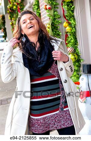 A 27 year old brunette woman shopping on a small town street with holiday decorations. View Large Photo Image Stock Photography - A 27 year old brunette woman shopping on a small town street with holiday decorations.. Fotosearch