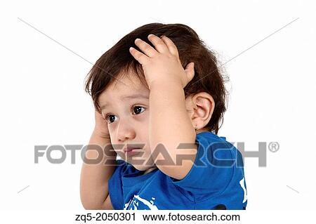 A 3 year old boy holding his head. Pune India View Large Photo Image Stock Image - A 3 year old boy holding his head. Pune India. Fotosearch