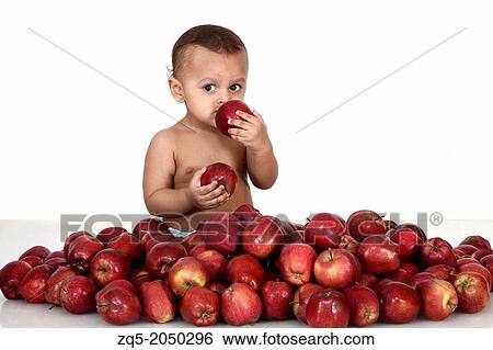 A 3 year old child eating from a heap of apples, Pune India View Large Photo Image Stock Photograph - A 3 year old child eating from a heap of apples, Pune India. Fotosearch