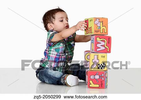 A 3 year old child playing with blocks. Pune India View Large Photo Image Stock Photo - A 3 year old child playing with blocks. Pune India. Fotosearch