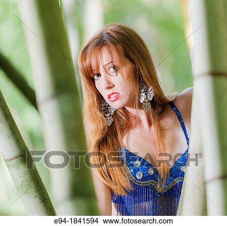A 30 year old redheaded woman in a bamboo forest wearing jeans and a shimmy top View Large Photo Image Picture - A 30 year old redheaded woman in a bamboo forest wearing jeans and a shimmy top. Fotosearch