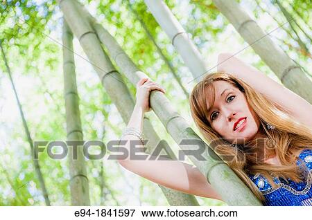 A 30 year old redheaded woman in a bamboo forest wearing jeans and a shimmy top View Large Photo Image Stock Photo - A 30 year old redheaded woman in a bamboo forest wearing jeans and a shimmy top. Fotosearch