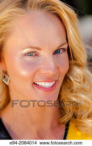 A 39 year old blond woman smiling at the camera. View Large Photo Image Picture - A 39 year old blond woman smiling at the camera.. Fotosearch