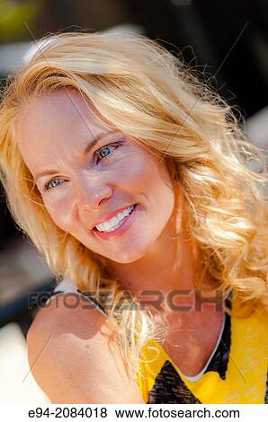 A 39 year old blond woman smiling looking away from the camera. View Large Photo Image Stock Photo - A 39 year old blond woman smiling looking away from the camera.. Fotosearch