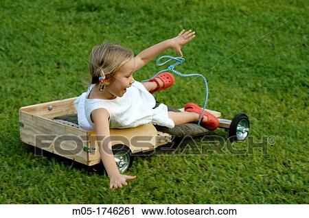 A 4 year old girl falling from her wooden kart View Large Photo Image Stock Image - A 4 year old girl falling from her wooden kart. Fotosearch