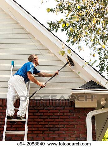 A 45 year old man on a ladder cleaning the wood siding of a house with a brush. View Large Photo Image Stock Image - A 45 year old man on a ladder cleaning the wood siding of a house with a brush.. Fotosearch