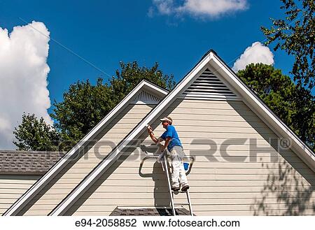 A 45 year old man on a ladder painting the white trim of a house. View Large Photo Image Stock Image - A 45 year old man on a ladder painting the white trim of a house.. Fotosearch
