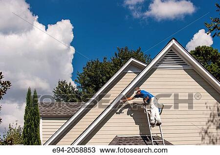 A 45 year old man on a ladder painting the white trim of a house. View Large Photo Image Stock Image - A 45 year old man on a ladder painting the white trim of a house.. Fotosearch