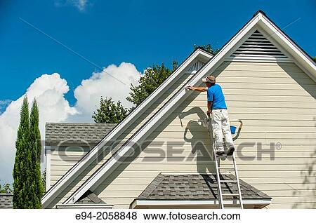 A 45 year old man on a ladder painting the white trim of a house. View Large Photo Image Stock Photo - A 45 year old man on a ladder painting the white trim of a house.. Fotosearch
