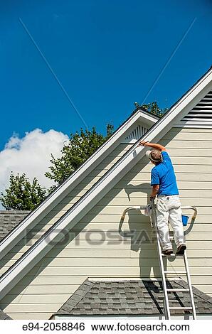 A 45 year old man on a ladder painting the white trim of a house. View Large Photo Image Stock Photograph - A 45 year old man on a ladder painting the white trim of a house.. Fotosearch