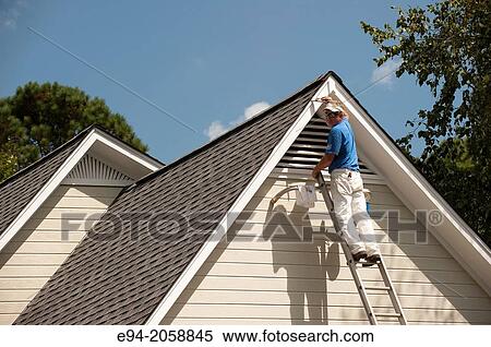 A 45 year old man on a ladder painting the white trim of a house. View Large Photo Image Stock Photography - A 45 year old man on a ladder painting the white trim of a house.. Fotosearch