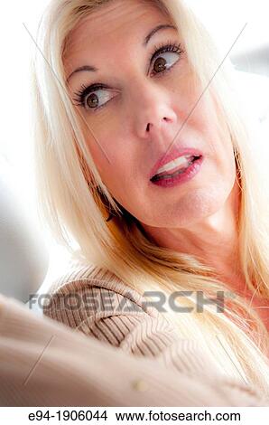 A 48 year old blond woman sitting in a car looking away from the camera View Large Photo Image Picture - A 48 year old blond woman sitting in a car looking away from the camera. Fotosearch