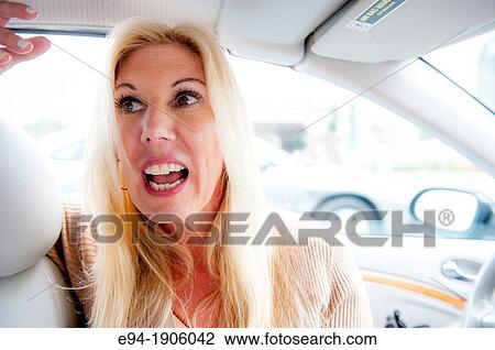 A 48 year old blond woman sitting in a car looking away from the camera View Large Photo Image Stock Image - A 48 year old blond woman sitting in a car looking away from the camera. Fotosearch