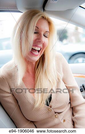 A 48 year old blond woman sitting in a car looking away from the camera View Large Photo Image Stock Photograph - A 48 year old blond woman sitting in a car looking away from the camera. Fotosearch