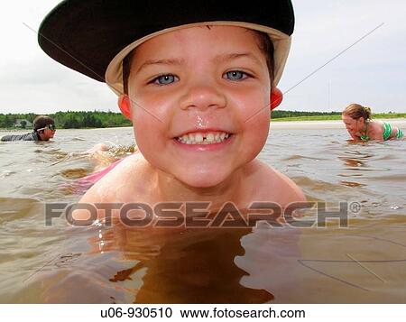 a 5 or 6 year old boy playing in the water at the beach View Large Photo Image Stock Image - a 5 or 6 year old boy playing in the water at the beach. Fotosearch