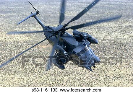 Stock Image - A 58th Special Operations Wing, 551st Special Operations Squadron, MH-53J Pave Low IIIE flies a training mission near Kirtland Air Force Base, NM. Fotosearch