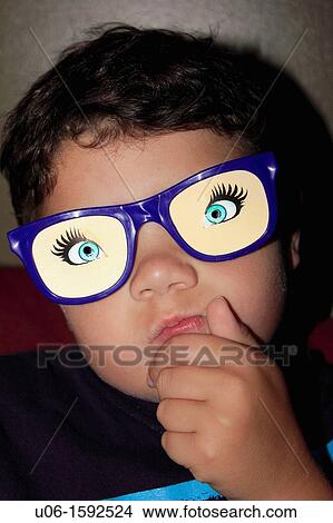 a 7 year old boy with funny glasses on View Large Photo Image Picture - a 7 year old boy with funny glasses on. Fotosearch