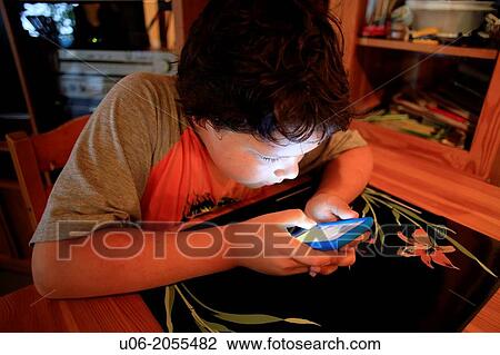 A 9 year old boy playing games on an apple ipod touch electronic device View Large Photo Image Stock Image - A 9 year old boy playing games on an apple ipod touch electronic device. Fotosearch