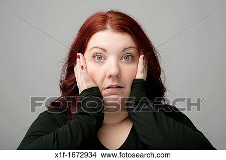 A auburn haired caucasian woman looking worried shocked concerned View Large Photo Image Picture - A auburn haired caucasian woman looking worried shocked concerned. Fotosearch