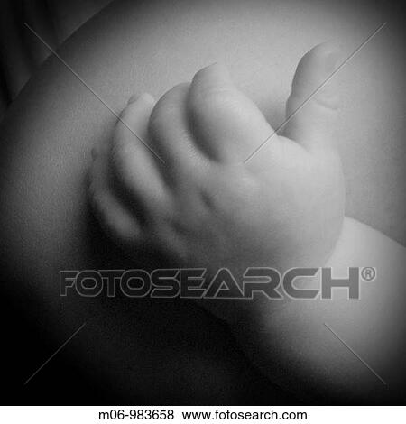 A baby's tiny fingers on it's mother's shoulder View Large Photo Image Stock Photo - A baby's tiny fingers on it's mother's shoulder. Fotosearch