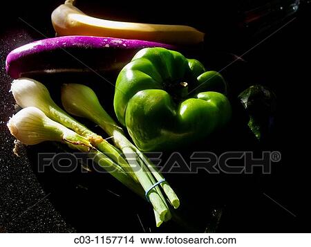 A banana, Japanese eggplant, green pepper, and a bunch of scallions form a still life in afternoon sun View Large Photo Image Picture - A banana, Japanese eggplant, green pepper, and a bunch of scallions form a still life in afternoon sun. Fotosearch
