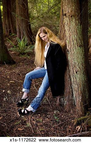 A Beautiful Woman With Very Long Blonde Hair Posing Outside Stock