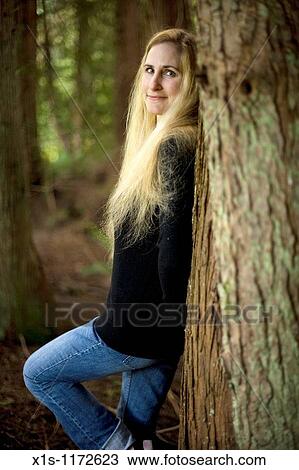A Beautiful Woman With Very Long Blonde Hair Posing Outside Stock