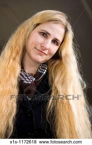 A beautiful woman with very long blonde hair posing outside View Large Photo Image Stock Photo - A beautiful woman with very long blonde hair posing outside. Fotosearch