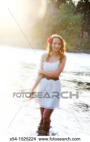A beautiful young caucasian woman outdoors in Spokane, Washington, USA, standing in the Spokane River. View Large Photo Image Picture - A beautiful young caucasian woman outdoors in Spokane, Washington, USA, standing in the Spokane River.. Fotosearch