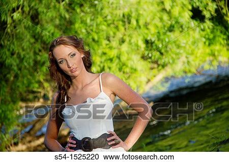 A beautiful young caucasian woman outdoors in Spokane, Washington, USA, standing in the Spokane River. View Large Photo Image Stock Image - A beautiful young caucasian woman outdoors in Spokane, Washington, USA, standing in the Spokane River.. Fotosearch
