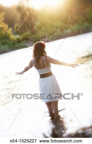 A beautiful young caucasian woman outdoors in Spokane, Washington, USA, standing in the Spokane River. View Large Photo Image Stock Photo - A beautiful young caucasian woman outdoors in Spokane, Washington, USA, standing in the Spokane River.. Fotosearch