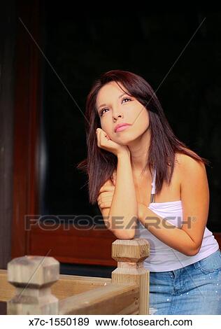 Stock Photo - A beautiful young lady enjoying her smartphone. Fotosearch