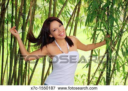 Stock Photo - A beautiful young lady in the bamboo. Fotosearch