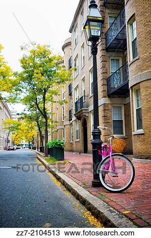 A bicycle parked on a residential Boston street. View Large Photo Image Stock Image - A bicycle parked on a residential Boston street.. Fotosearch