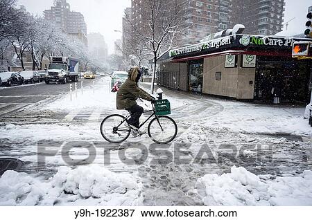 A bicyclist travels on a snow-covered bike path in the Chelsea neighborhood of New York A winter storm with high winds dumped snow and rain on the northeast U S New York City is expected to get one to 3 inches View Large Photo Image Stock Photo - A bicyclist travels on a snow-covered bike path in the Chelsea neighborhood of New York A winter storm with high winds dumped snow and rain on the northeast U S New York City is expected to get one to 3 inches. Fotosearch