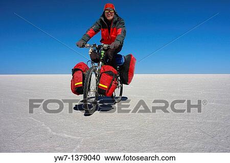 A biker is cycling through the frozen salt lake called? Salar de Uyuni? in Bolivia View Large Photo Image Stock Image - A biker is cycling through the frozen salt lake called? Salar de Uyuni? in Bolivia. Fotosearch