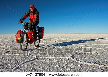 A biker is cycling through the frozen salt lake called? Salar de Uyuni? in Bolivia View Large Photo Image Stock Image - A biker is cycling through the frozen salt lake called? Salar de Uyuni? in Bolivia. Fotosearch