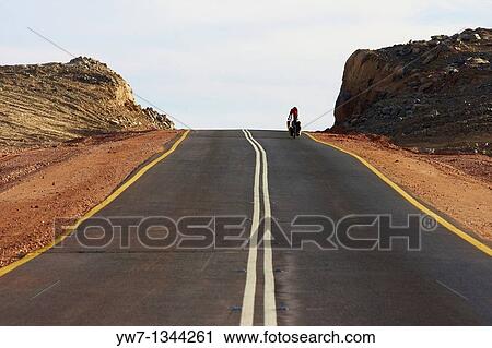 A biker on the road leading to Khartoom in Sudan View Large Photo Image Stock Image - A biker on the road leading to Khartoom in Sudan. Fotosearch