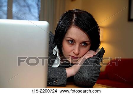 A black haired young woman at desk. View Large Photo Image Picture - A black haired young woman at desk.. Fotosearch