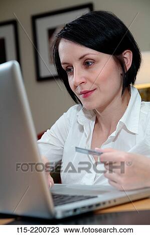 A black haired young woman shopping on the internet. View Large Photo Image Stock Image - A black haired young woman shopping on the internet.. Fotosearch