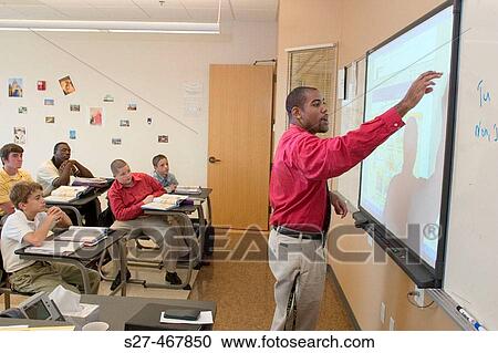 A black instructor teaches French to a class of students using a? smart board? or electronic black board. View Large Photo Image Stock Image - A black instructor teaches French to a class of students using a? smart board? or electronic black board.. Fotosearch