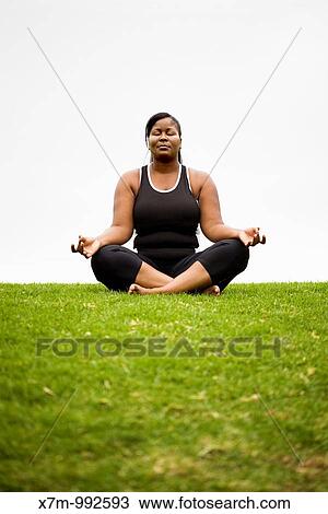A black plus size female model in Dhyana yoga pose View Large Photo Image Stock Image - A black plus size female model in Dhyana yoga pose. Fotosearch