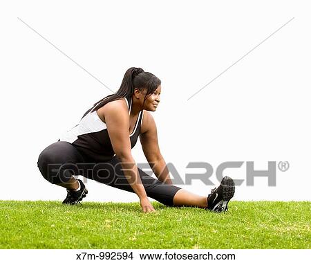 A black plus size female model plus size model in stretching position View Large Photo Image Picture - A black plus size female model plus size model in stretching position. Fotosearch
