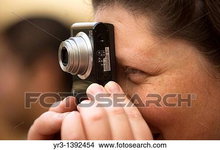 Picture - A blind female student takes a pictureduring a photography workshop for the blind and visually impaired, imparted by Sight of Emotion organization in Mexico City, February 24, 2011 . Fotosearch