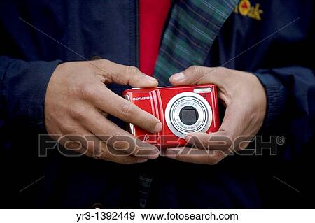 A blind female student touches a camera View Large Photo Image Stock Photo - A blind female student touches a camera. Fotosearch