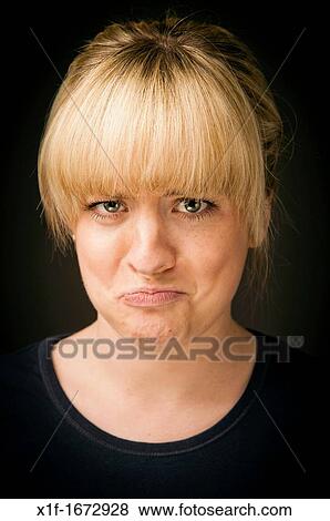 a blonde haired girl woman pulling a frowning face pout pouting moody View Large Photo Image Stock Photo - a blonde haired girl woman pulling a frowning face pout pouting moody. Fotosearch