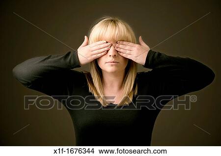 a blonde haired girl woman with hand over her eye View Large Photo Image Picture - a blonde haired girl woman with hand over her eye. Fotosearch