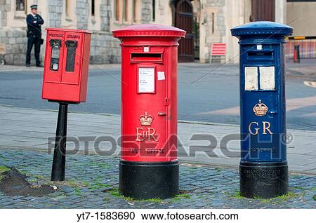 Stock Image - A blue Royal Mail post box George Regina next to a more common red one Elizabeth Regina in Windsor, Berkshire, UK. Fotosearch